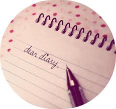 Pen writing words 'Dear Diary' in notebook