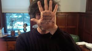 Neil Gaiman with the words 'Write. Finish Things. Keep Writing' written on his hand. Image: redesignrevolution.com